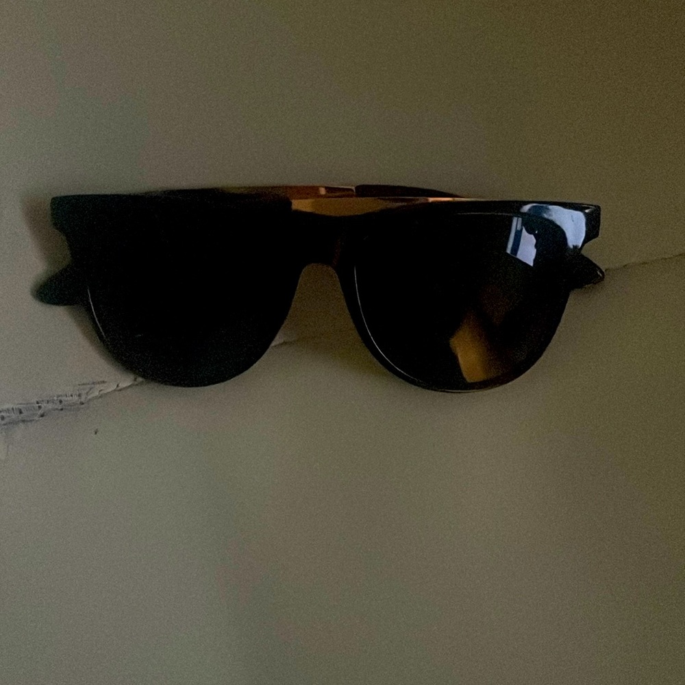Super cool black sunglasses with gold band.